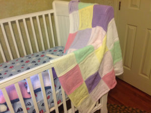 A crib with blankets waits for a new arrival