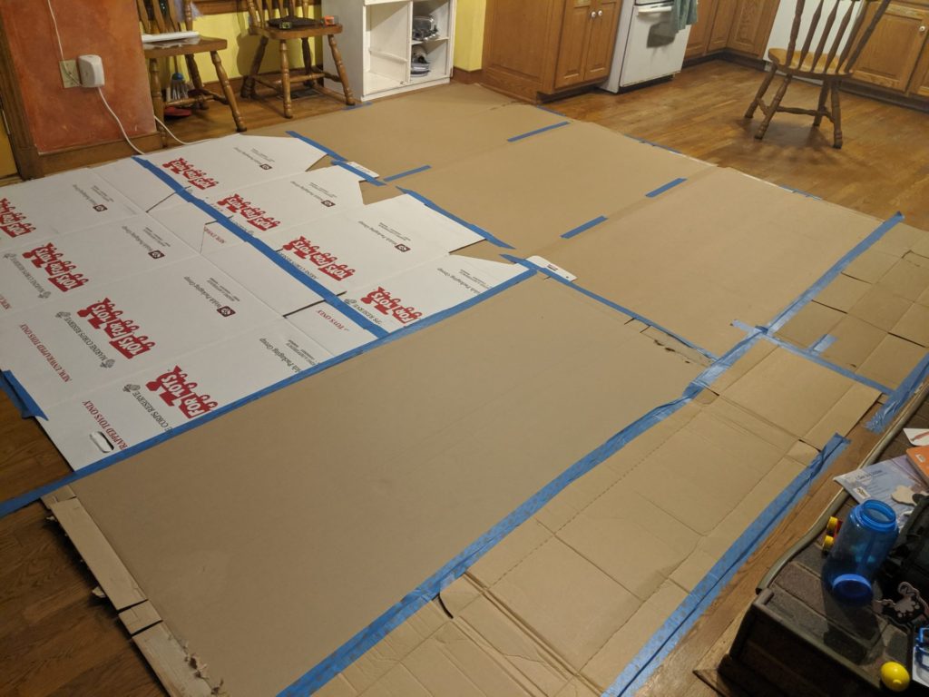 cardboard boxes laid out on kitchen floor for blocking