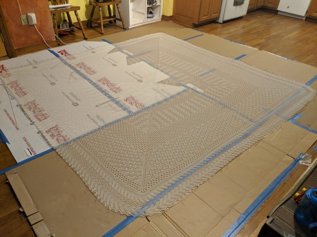 giant knit chuppah blocking on cardboard boxes