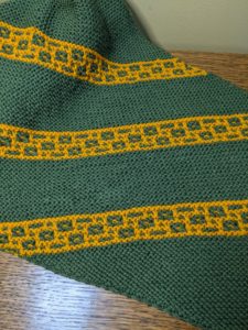 green and gold shawl with recently darned and rewoven hole